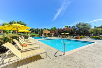 Pool Area with Yellow Umbrellas, Lounge Chairs, and Pool at Fountains of Fair Oaks, Fair Oaks, CA 95628